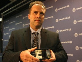 Toronto Police Det. Ian Nichol holds an ATM skimming device that was seized from a Toronto hospital.  ( LAURA PEDERSEN, Toronto Sun)