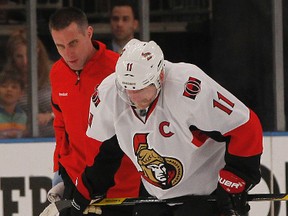 Daniel Alfredsson gets helped off the ice after receiving a hit to the head during second period action Saturday night, April 14, 2012 in New York. His status for Wednesday's Game 4 is up in the air.
(Tony Caldwell/QMI Agency)