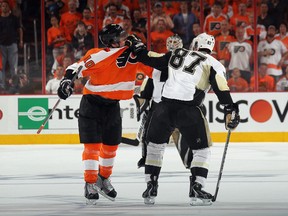 Brayden Schenn, of the Philadelphia Flyers, and Sidney Crosby, of the Pittsburgh Penguins dance in the third period in Game 3 of their Eastern Conference quarterfinal series. (Bruce Bennett/Getty Images/AFP)