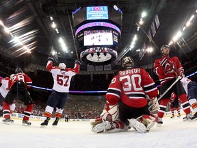 Marcel Goc, of the Florida Panthers, celebrates after teammate Jason Garrison scored a goal in the first period against goalie Martin Brodeur, of the New Jersey Devils, in Game 3 of the Eastern Conference Quarterfinals during the 2012 NHL Stanley Cup Playoffs. (Bruce Bennett/Getty Images/AFP)
