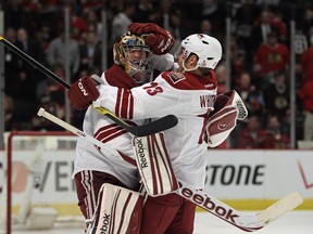 Mike Smith and Ray Whitney of the Phoenix Coyotes celebrate a win against the Chicago Blackhawks. (Jonathan Daniel/Getty Images)