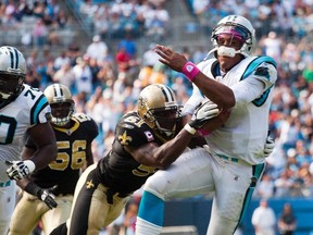 Carolina Panthers' quarterback Cam Newton is hit by New Orleans Saints' middle linebacker Jonathan Vilma during an NFL football game in Charlotte, North Carolina October 9, 2011. (Chris Keane/REUTERS)