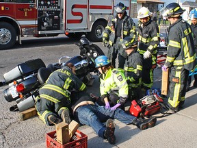 Emergency workers tend to the scene of a car-motorcycle crash in Welland. (Postmedia Network file photo)
