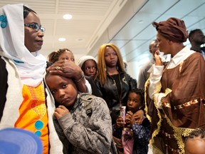 Kankou Keita and her five children at Pierre Elliot Trudeau Airport earlier this month. (Joel Lemay/QMI Agency)