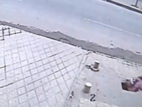 A teenage girl fell through a sidewalk in Xi'an, the capital of the China's northwest Shaanxi Province, after she failed to notice warning signs. A video of the girl walking along the sidewalk and using her cellphone on March 25 has been posted to YouTube. It has been generating lots of interest on Tuesday, April 24, 2012. (YOUTUBE SCREENSHOT)