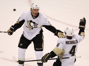 Pittsburgh Penguins' Jordan Staal (L) celebrates with teammate Zbynek Michalek after scoring on the Philadelphia Flyers during the first period in Game 4 of their NHL Eastern Conference quarterfinal playoff hockey series in Philadelphia, April 18, 2012. (REUTERS/Tim Shaffer)