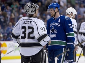 Daniel Sedin, of the Vancouver Canucks, shakes hands with goalie Jonathan Quick, of the Los Angeles Kings, after losing 2-1in the first overtime period in Game 5 of the Western Conference quarterfinals. (Rich Lam/Getty Images/AFP)