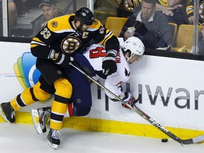 Bruins defenceman Zdeno Chara (left) checks Capitals forward Alex Ovechkin during Game 5 of their playoff series. (Brian Snyder/Reuters)