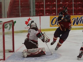 Phenix's Tristan Trembley tries to tip the puck past the Moncton Flyers' Nathan Armstrong Tuesday in Leduc. (Bobby Roy, QMI Agency)