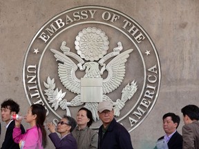 People line up outside the US embassy in Beijing on April 27, 2012. (AFP PHOTO/Ed Jones)