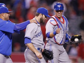 Brandon Morrow (right) gets congratulated by teammate Ricky Romero after his complete-game shutout of the Angels on Thursday night. (Reuters)