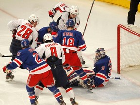 Rangers goaltender Henrik Lundqvist makes a save against the Capitals behind a scramble in his crease during Game 5 of their NHL Eastern Conference semifinal series at Madison Square Garden in New York, N.Y., May 7, 2012. (GARY HERSHORN/Reuters)
