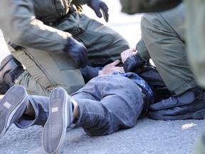 Police officers in riot squad of the Quebec Provincial Police have arrested a young man in the back of the hotel Le Victorin, as part of the demonstration against the Liberal government on Saturday, May 5, 2012. (MAXIME DELAND/QMI AGENCY)