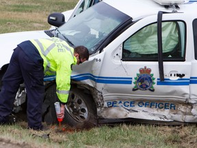 A police officer marks the scene of a fatal crash involving a Peace Officer on Highway 21 south of Twp Rd 512, southeast of Edmonton, Alberta on Tuesday, May 8, 2012. The male driver of a southbound Honda Civic crossed the centre line and struck the fully marked Strathcona County Chevy Tahoe. The driver of the Civic was pronounced dead in hospital and the female officer is being treated for non-life threatening injuries. AMBER BRACKEN/EDMONTON SUN/QMI AGENCY
