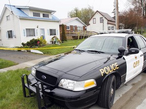 Members of the Prince Edward OPP stands guard outside a house at 51 Stanley St. in Bloomfield, ON on Tuesday morning, May 1, 2012, where, police said, a 46-year-old man was found dead at approximately 12:10 a.m. - JEROME LESSARD /THE INTELLIGENCER/QMI AGENCY
