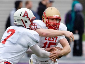 Sebastien Levesque  of the University of Laval takes a hand off from Acadia University's Kyle Graves during the CIAU's East-West Bowl Week in London, Ont. last May. Graves was just signed by the Montreal Alouettes. (Derek Ruttan/QMI Agency)