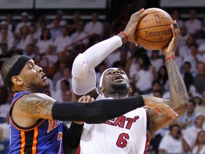 Miami Heat’s LeBron James (right) drives to the basket on New York Knicks’ Carmelo Anthony during the first quarter of their playoff game on Wednesday night. (Reuters)