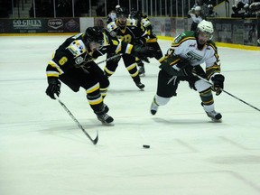 Portage Terriers forward Brendon Fornwald and Humboldt Broncos defenceman Jonathan Parisen during the ANAVET Cup. The win sent the Terriers to the RBC Cup. (DAN FALLOON/QMI Agency)