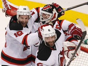 Winnipeg's Travis Zajac (19) celebrates with teammates Martin Brodeur and Andy Greene (6) after the New Jerseyt Devils defeated the Philadelphia Flyers in Game 5 of their NHL Eastern Conference semi-final playoff hockey series in Philadelphia May 8, 2012.
