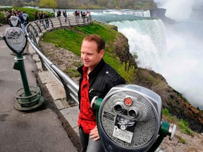 Nik Wallenda poses for a photo after a news conference discussing his upcoming wire walk over the Canadian (Horseshoe) Falls, as he stands at the American Falls, Niagara Falls May 2, 2012. (REUTERS/Doug Benz)