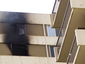Smoke lingers outside a windows at Millside Estates, on 99 Avenue and 104 Street, after a fire broke out on the 18th floor in Edmonton, Alberta on Tuesday, May 15, 2012.  AMBER BRACKEN/EDMONTON SUN/QMI AGENCY