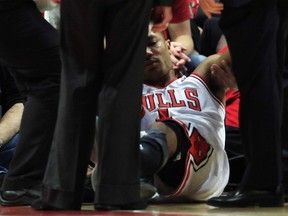 Chicago Bulls' Derrick Rose is helped off  the court after getting hurt during the second half of an NBA Eastern Conference quarter-final playoff basketball game against the Philadelphia 76ers in Chicago. (REUTERS)