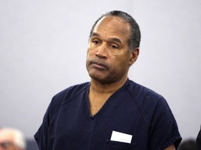 O.J. Simpson listens as District Court Judge Jackie Glass (not in photo) reads his sentence at the Clark County Regional Justice Center in Las Vegas, Nevada in this December 5, 2008 file photograph. (REUTERS/Issac Brekken/Files)