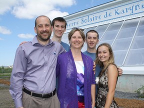 After two years of construction, the Maisonneuve family — left to right Carl, Marc, Mary Lou, Paul and Elyse — stand in front of Gisele Lalonde high school's first solar greenhouse classroom. Since eight-year-old Karyne Maisonneuve passed away in 2006, the family has dedicated their time to build sustainable energy projects at the school, where their children attend.
(MIKE AUBRY/OTTAWA SUN/QMI AGENCY)
