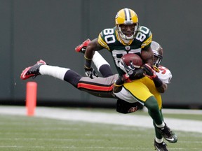 Tampa Bay Buccaneers' Elbert Mack tries to tackle Green Bay Packers' Donald Driver in the second half during their NFL football game in Green Bay, Wisconsin November 20, 2011. (Darren Hauck/REUTERS)