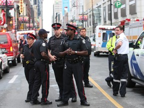 Officers at the scene of Saturday night's shooting. (CRAIG ROBERTSON, Toronto Sun)