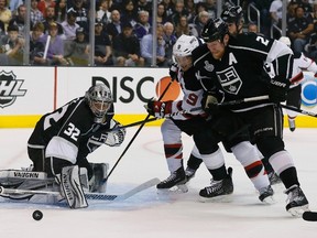 Kings goaltender Jonathan Quick makes a save on Devils forward Zach Parise as he is checked by defenceman Matt Greene during Game 3 of the Stanley Cup final at the Staples Center in Los Angeles, Calif., June 4, 2012. (LUCY NICHOLSON/Reuters)