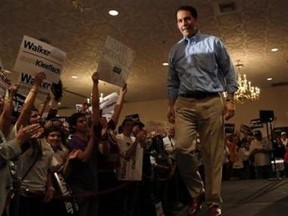 Republican Wisconsin Governor Scott Walker walks on the stage in Milwaukee, Wisconsin. (REUTERS/Darren Hauck)