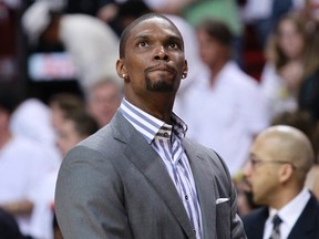 Miami Heat forward Chris Bosh stands near the bench before his team met the Boston Celtics during Game 2 of their Eastern Conference Finals NBA basketball playoffs in Miami, Florida May 30, 2012. (REUTERS/Andrew Innerarity)