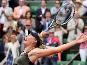 Maria Sharapova of Russia celebrates after winning her women’s singles final match against Sara Errani of Italy at the French Open tennis tournament at the Roland Garros stadium in Paris June 9, 2012. REUTERS/Francois Lenoir
