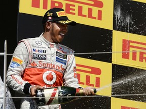 Mercedes F-1 driver Lewis Hamilton of England celebrates with champagne after his win of the Montreal Formula 1 Grand Prix at Gilles Villeneuve Circuit ON Sunday. (BENOIT PELOSSE/QMI AGENCY)