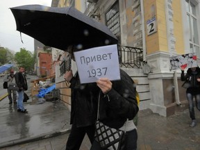 Protesters walk with placards during an anti-government protest in Russia's far eastern port of Vladivostok June 12, 2012. The placard (L) reads "Hello 1937", a reference to the deadliest year of Soviet dictator Josef Stalin's repression. (REUTERS/Yuri Maltsev)