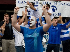Greek soccer fans had mixed feelings at the Trapezzi on the Danforth Tuesday. They hit the streets with a lot of passion that soon turned to gloom as there team lost.  (Dave Thomas/Toronto Sun)