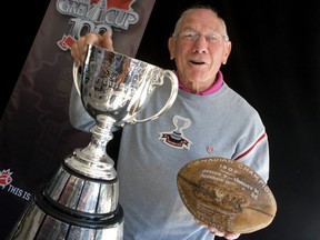 Russ Jackson who played quarteback in the 1960, '68, '69 Grey Cup games holds the trophy and a ball from the 1909 game. Jackson, 75, was on hand to commemorate the playing of the 100th Grey Cup game in November at Rogers Centre at the site of the first game — Rosedale field. (Dave Thomas/Toronto Sun)