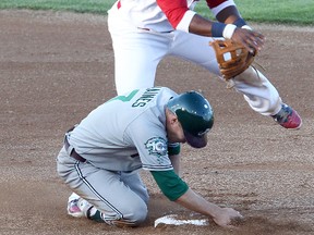 Winnipeg Goldeyes second baseman Yurendell de Caster (top) makes a throw to first during Friday’s game.