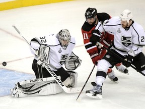 Los Angeles Kings goalie Jonathan Quick lets in a goal as New Jersey Devils' Stephen Gionta and Kings' Colin Fraser look on during the third period in Game 2 of the NHL Stanley Cup hockey final in Newark, New Jersey, June 2, 2012. (Ray Stubblebine/REUTERS)