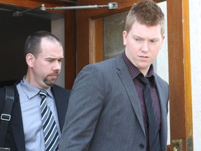 Michael Lea The Whig-Standard
Mackenzie McDonald, right, escorted by Kingston Police detective Steven Koopman, leaves the Kingston court house in May 2010.
