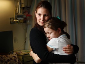 Rebecca Aubin holds her daughter, Courtney, in their hospital room at the Children's Hospital of Eastern Ontario Monday, June 4, 2012. Rebecca is donating one of her kidneys to help Courtney overcome a blood disease.  (DARREN BROWN Ottawa Sun)