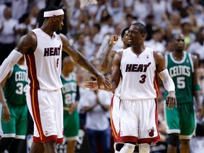 Miami Heat's LeBron James celebrates with teammate Dwyane Wade in the fourth quarter against the Boston Celtics during Game 7. (Andrew Innerarity/REUTERS)