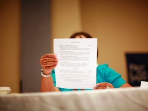 A woman looks over a resume during a job fair in New York June 11, 2012. (REUTERS)