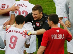 Poland's goalkeeper Przemyslaw Tyton (C) embraces Robert Lewandowski at the end of their Group A Euro 2012 soccer match against Russia at the National stadium in Warsaw June 12, 2012. (REUTERS)