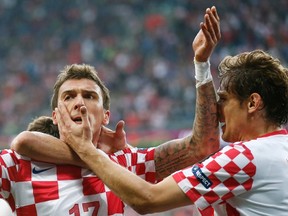 Croatia's Mario Mandzukic (L) celebrates with Nikica Jelavic after scoring a goal against Italy during their Group C Euro 2012 soccer match at the city stadium in Poznan June 14, 2012. (REUTERS)