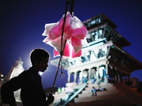 A boy selling cotton candy waits for customers on the streets of Kathmandu June 11, 2012. (REUTERS/Navesh Chitrakar)