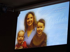 A picture of Susan Powell is seen on a screen with her children Charles (R) and Braden Powell during funeral services for the boys in Puyallup, Washington February 11, 2012. Powell disappeared in Utah in late 2009 and is presumed to have been slain by her late husband. Her children were killed in a house fire by her husband earlier this year. (REUTERS FILE)