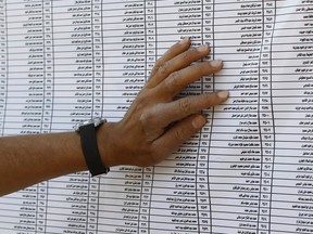 A man checks for his name before casting his vote during the Egyptian presidential election at a polling station in Giza, on the outskirts of Cairo on June 16, 2012. (REUTERS/Amr Abdallah Dalsh)