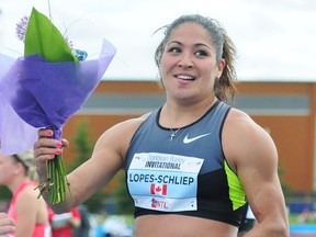 Canadian hurdler Priscilla Lopes-Schliep accepts a bouquet of flowers after winning the women's 100-metre hurdle with a time of 12.76 seconds at the Donovan Bailey Invitation Track and Field Meet on Saturday at Foote Field.
trevor Robb, QMI Agency
